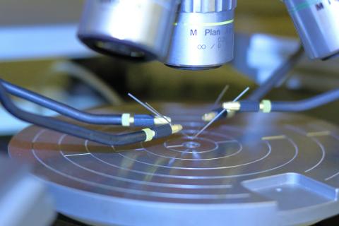 Modern microscope in clean laboratory, representing precision testing and scientific debugging